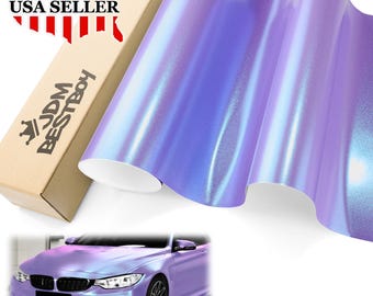 May include: A roll of iridescent purple car wrap material with a pearlescent finish. The material is next to a cardboard box with the text "USA SELLER" and "JDM BESTBOY". A car is shown with the same color wrap.