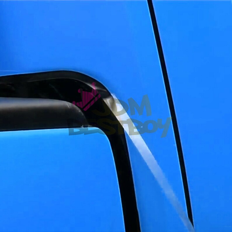 May include: Close-up of a blue car door with a black trim. The door has a slight crease in the paint.