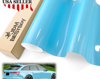 May include: A roll of light blue vinyl car wrap film. The film is glossy and has a smooth surface. The film is shown wrapped around a car, and the car is a light blue wagon. The image also shows a box with the text "JDM BESTBOY" and "USA SELLER" on it.