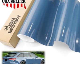 May include: A roll of glossy, blue vinyl wrap with a white backing, next to a cardboard box with "USA SELLER" and "JDM BESTBOY" printed on it. A blue car is shown in the bottom corner.