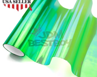 May include: A roll of green iridescent vinyl car wrap film. The film is rolled up and has a slight bend in it. The film is reflective and has a holographic effect.
