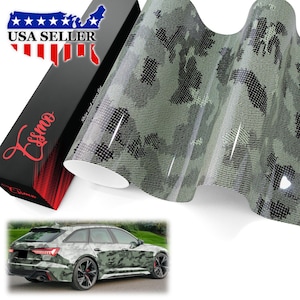 May include: A roll of adhesive vinyl wrap featuring a green, black, and light gray camouflage pattern with a textured finish. The packaging box is black with red text reading Essmo and a USA Seller graphic. A station wagon car displays the wrap.