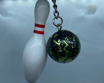 Bowling Pin with Green and Black Patterned Bowling Ball