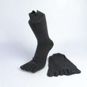 May include: A pair of gray toe socks. One sock is on a foot and the other is laid flat.