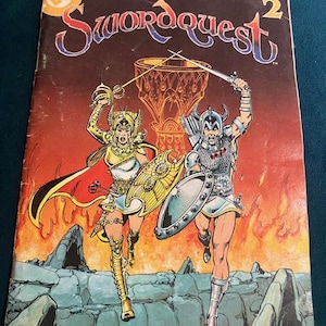 May include: Comic book cover for Swordquest 2, featuring two figures in armor with swords and shields. The background is a fiery scene with a large chalice. The DC Comics logo is in the upper left corner.