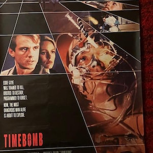 May include: A movie poster for "Timebomb" features a dark background with images of actors and a futuristic design. The title "TIMEBOMB" is in red. Text includes "EDDIE KAYE WAS TRAINED TO KILL, ORDERED TO DESTROY, PROGRAMMED TO FORGET. NOW, THE MOST DANGEROUS MAN ALIVE IS ABOUT TO EXPLODE."