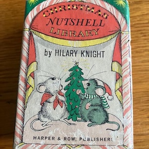 May include: A rectangular book titled Christmas Nutshell Library by Hilary Knight, published by Harper & Row. The cover features two illustrated mice standing beside a decorated Christmas tree, framed by red and white striped curtains.