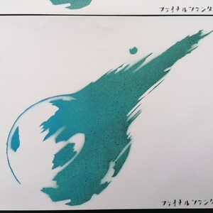 May include: A teal and blue spray paint stencil of the Final Fantasy VII logo. The logo is a stylized sphere with a comet tail.