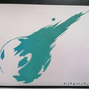 May include: A teal blue spray paint stencil of the Final Fantasy VII logo on a white background. The logo is a stylized comet with a tail.