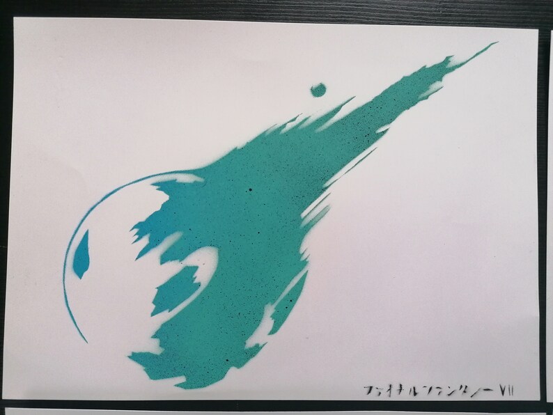 May include: A teal blue spray paint stencil of the Final Fantasy VII logo on a white background. The logo is a stylized comet with a tail.