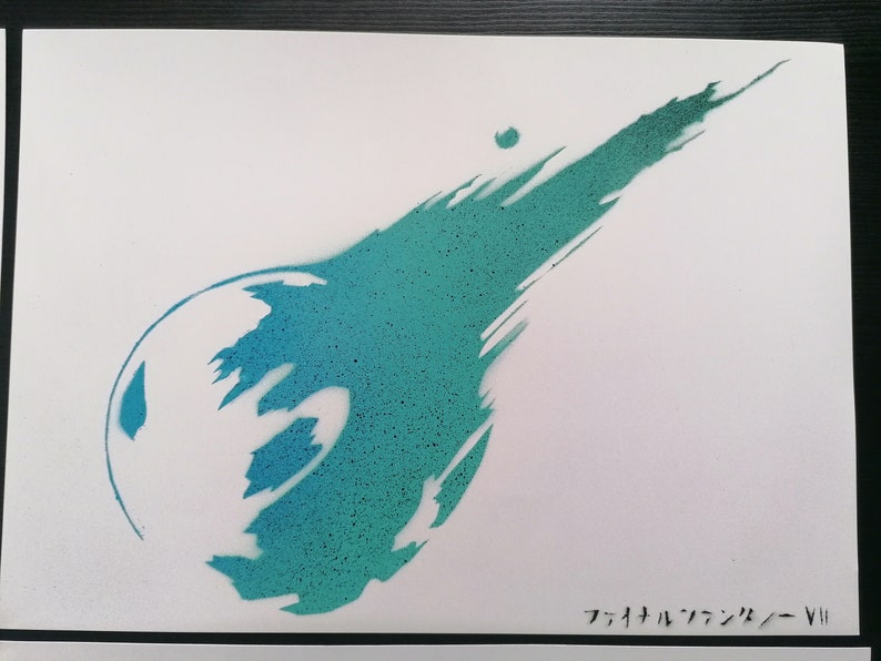 May include: A teal and blue spray paint stencil of the Final Fantasy VII logo. The logo is a stylized comet with a large, round head and a long, thin tail.