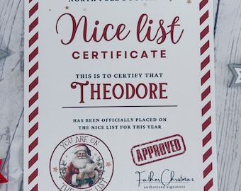 May include: A personalized "Nice List" certificate with a red and white striped border. The certificate includes the text "Nice List Certificate" and "Theodore" is printed on the certificate. A stamp that says "Approved" and a Santa Claus seal are also on the certificate.