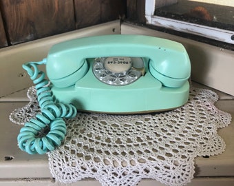 Vintage turquoise Northern Electric rotary dial telephone