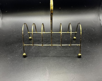Suporte para torradas vintage em metal dourado, estilo moderno de meados do século XX.