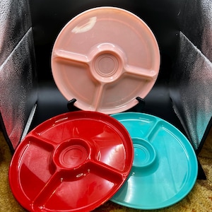 May include: A white ceramic mug with a black handle and the text "But First, Coffee" in a black, handwritten-style font. The mug is on a white surface.