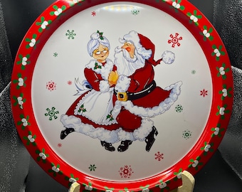 Bandeja de servir de hojalata vintage de Papá Noel y Mamá Noel, redonda, con muérdago y motivos navideños.