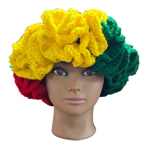 May include: A crocheted hat in red, yellow, and green colors. The hat is made of yarn and has a flower-like design.