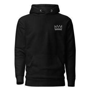 May include: Black hoodie with a front pocket and a drawstring hood. A white crown graphic is on the upper left chest. The hoodie is made of a soft material.