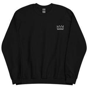 May include: Black sweatshirt with a white embroidered crown on the left chest.