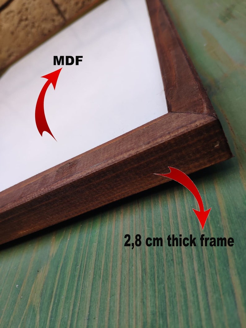 May include: A close-up of a brown wooden frame with a white MDF backing. The frame is 2.8 cm thick.