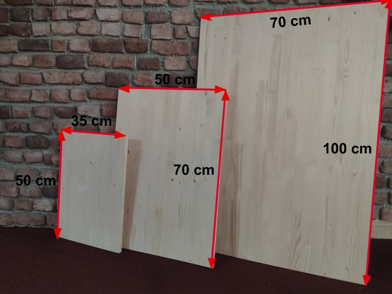May include: Three wooden boards of different sizes. The largest board is 70 inches by 100 inches. The middle board is 50 inches by 70 inches. The smallest board is 35 inches by 50 inches.