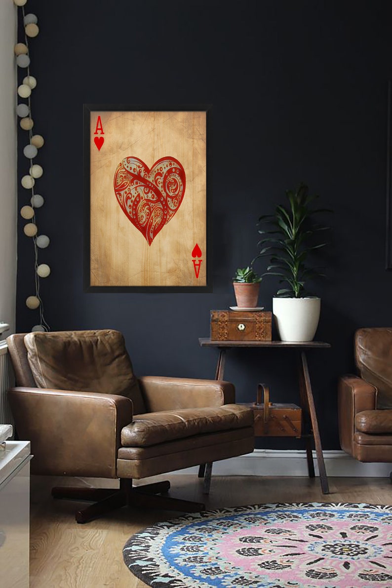 May include: A framed print of the Ace of Hearts playing card with a red, ornate heart design on a vintage-style background.