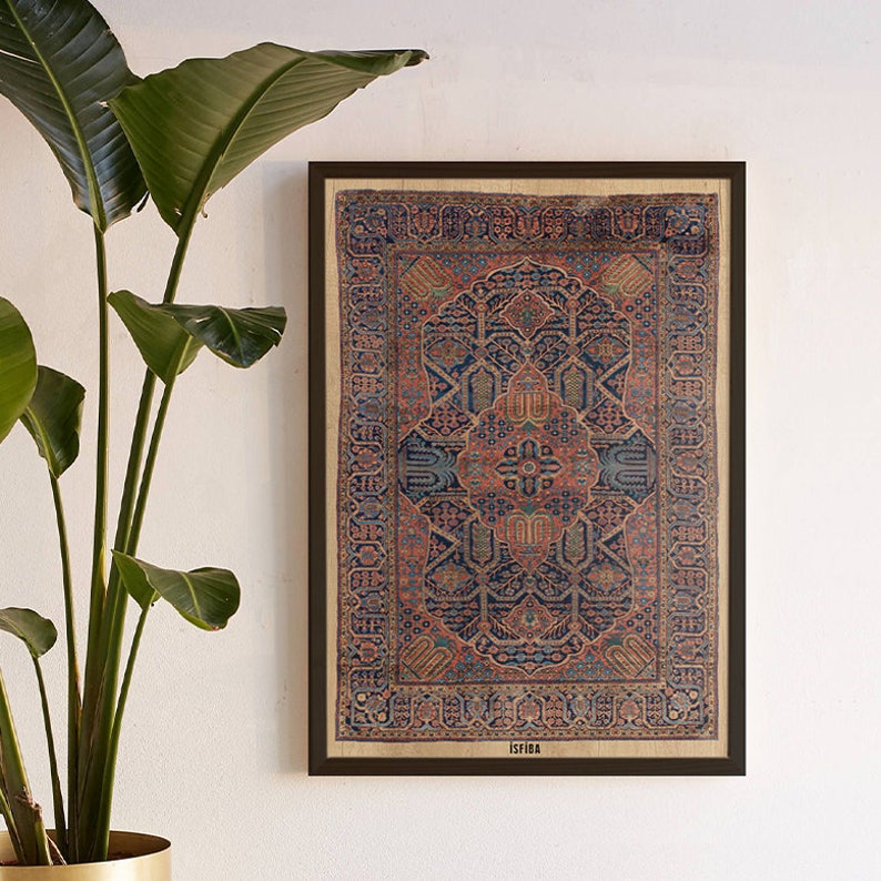 May include: A framed print of a vintage rug with intricate geometric patterns in shades of blue, red, and beige. The rug is surrounded by a brown frame and the word "ISFAHAN" is printed in the bottom right corner.