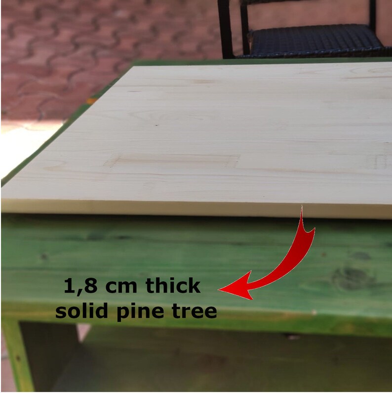 May include: Close-up of a light wood tabletop, showing the grain of the wood. The tabletop is 1.8 cm thick and made of solid pine tree.
