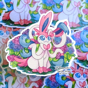 May include: A watercolor illustration of a pink and white Pokemon character with blue and white accents. The character is surrounded by purple flowers and green leaves. The image includes the text "@Zuccini Don't Re-Upload My Content!"