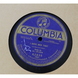 May include: A blue and gold Columbia Records 78 RPM record with the title "I Gave Her That" sung by Al Jolson. The record number is A.2835.