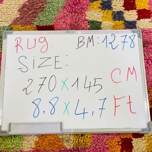 May include: Whiteboard with the text "Rug: BM:1278 Size: 270 x 145 CM 8.8 x 4.7 Ft"