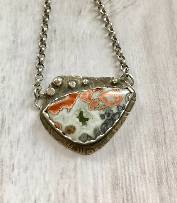 Tourquoise and Spring Green Spiral on black glass with rainbow dichroic glass center on sterling silver necklace by Deborah Tom