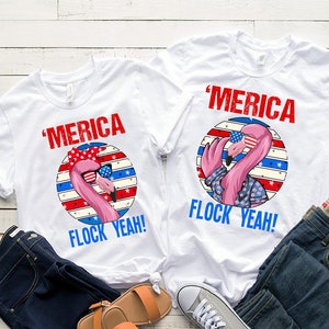 May include: Two white t-shirts with a pink flamingo wearing sunglasses and a red, white, and blue bandana. The text on the shirts says "'Merica Flock Yeah!"