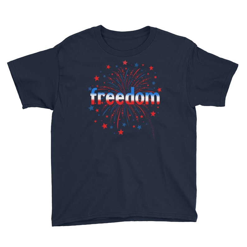 May include: Navy blue youth t-shirt with a red, white, and blue firework graphic and the word "freedom" in a red, white, and blue gradient.