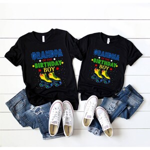 May include: Black t-shirts with the text "GRANDPA OF THE BIRTHDAY BOY" and "GRANDMA OF THE BIRTHDAY BOY" in blue, green, and yellow. The shirts feature a roller skate graphic. White trainers and blue jeans are also in the image.