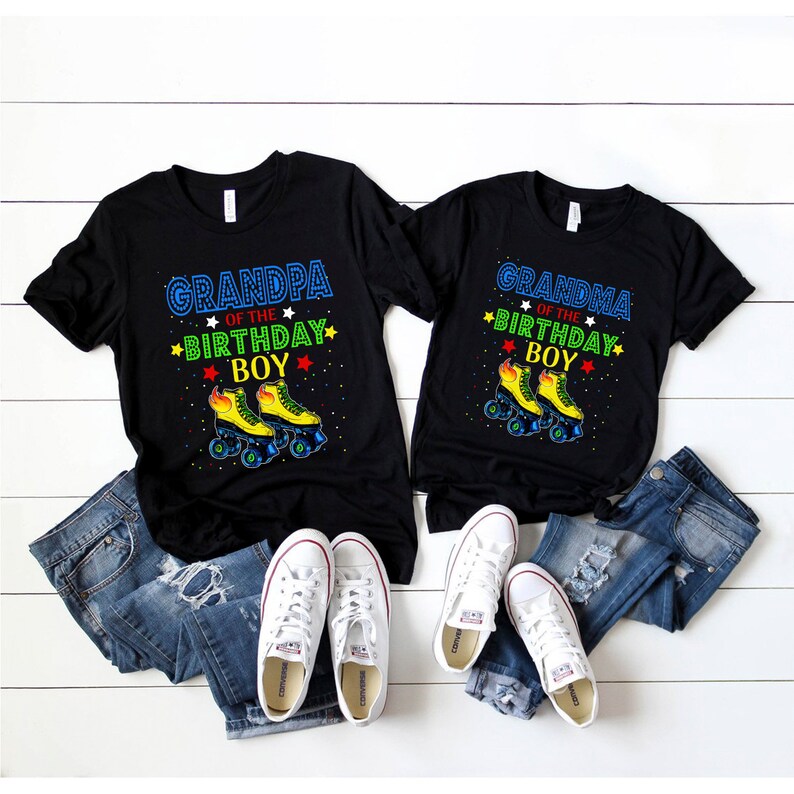 May include: Black t-shirts with the text "GRANDPA OF THE BIRTHDAY BOY" and "GRANDMA OF THE BIRTHDAY BOY" in blue, green, and yellow. The shirts feature a roller skate graphic. White trainers and blue jeans are also in the image.