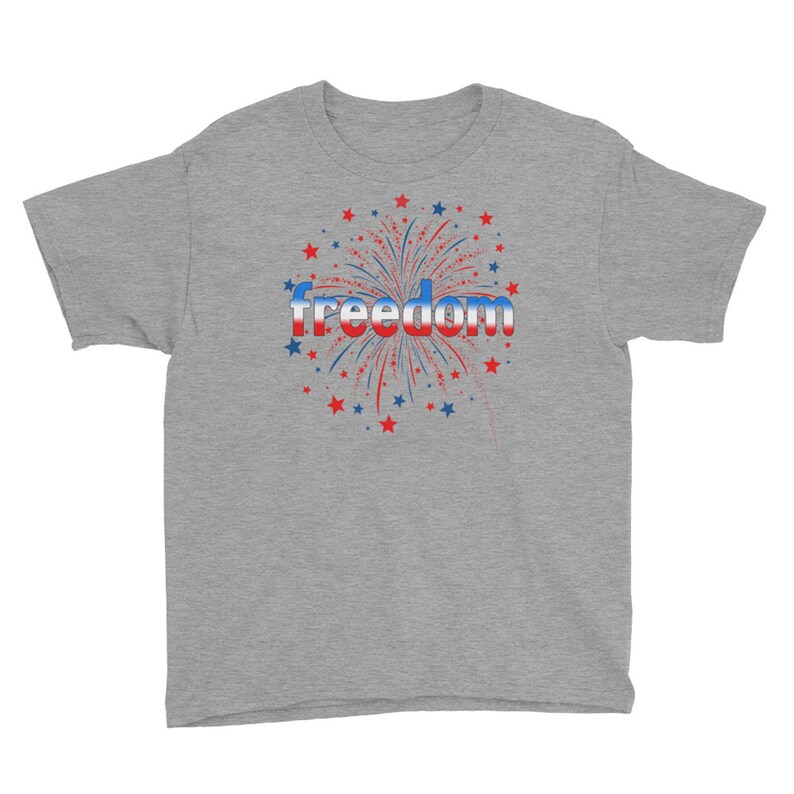 May include: A heather grey youth t-shirt with a red, white, and blue firework graphic and the word "freedom" in a red, white, and blue gradient.