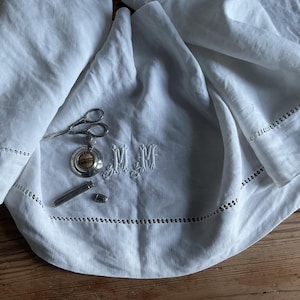 MM monogram hand embroidered on top of a sheet for crafting, sewing, framing