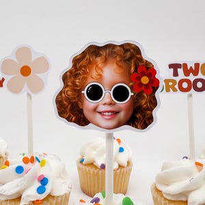 May include: A set of six cupcake toppers featuring a girl with red hair wearing sunglasses, a flower, and the text "TWO GROOVY".