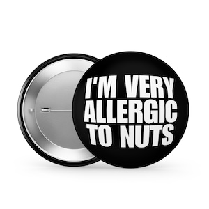 May include: A black button with white text that reads "I'm Very Allergic To Nuts".