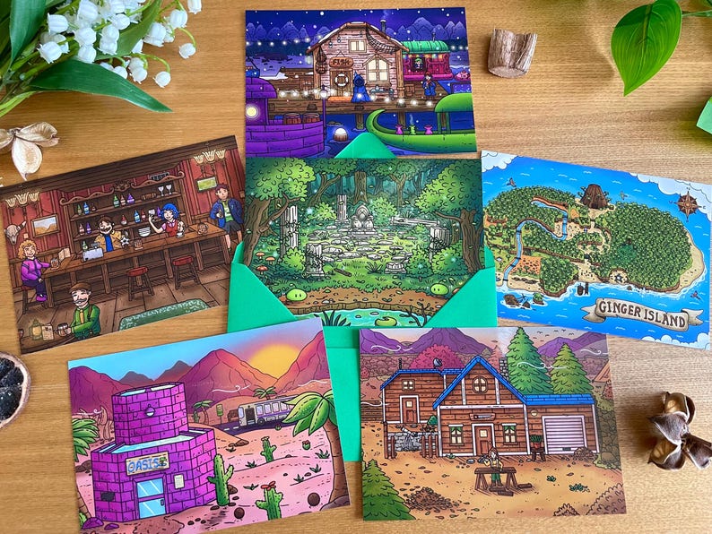 May include: A collection of colorful illustrated postcards featuring various scenes. One depicts a bar interior, another a forest, and a third shows a map labeled "Ginger Island." Other cards show a desert scene and a house.