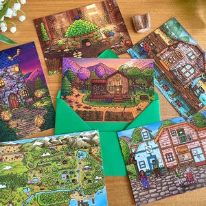 May include: A collection of illustrated postcards featuring whimsical scenes. The cards depict various settings, including a detailed map, a cozy cottage, and a fantastical tower. The cards are arranged with a green envelope and decorative elements.