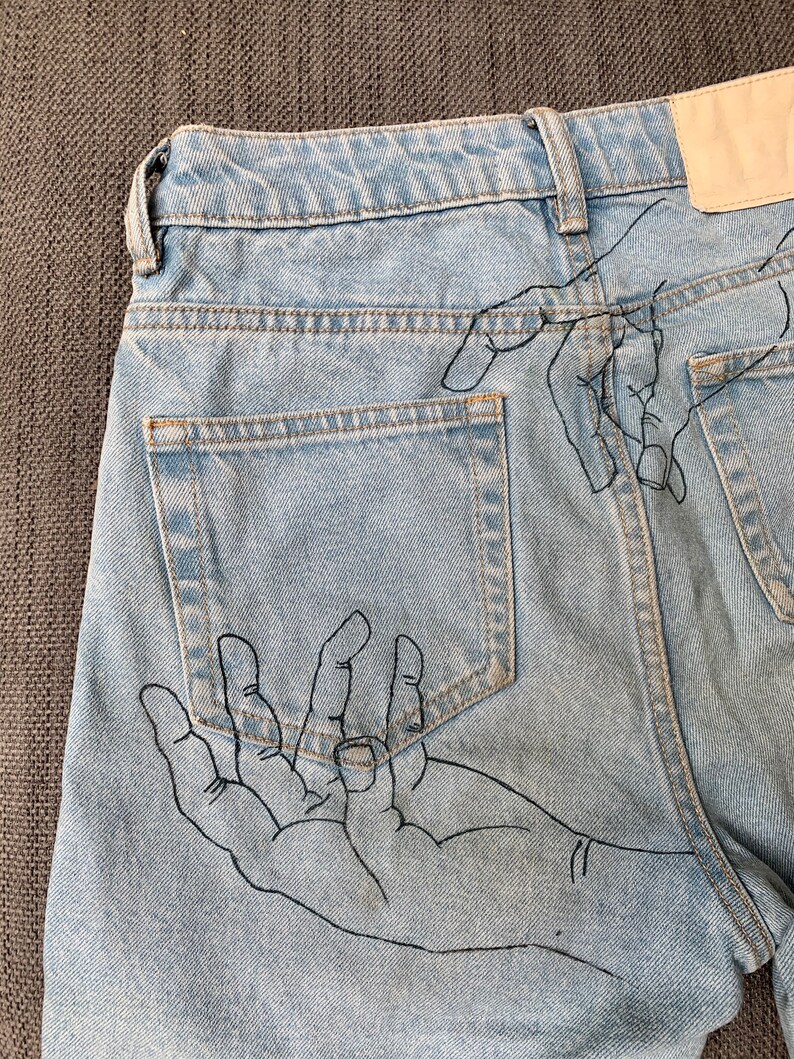 hands painted on jeans