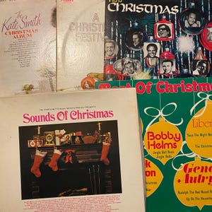 May include: A collection of vintage vinyl record covers featuring Christmas themes. Titles include The Kate Smith Christmas Album, A Christmas Festival, This Is Christmas, Sounds Of Christmas, and Best Of Christmas with various holiday graphics.