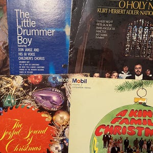 May include: A collection of four vintage vinyl record covers featuring Christmas themes. Titles include The Little Drummer Boy, O Holy Night, The Joyful Sound of Christmas, and A King Family Christmas, with festive imagery of ornaments and choirs.