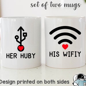May include: Set of two white ceramic mugs with black and red designs. One mug has a USB symbol with a red heart and the text "HER HUBY". The other mug has a wifi symbol with a red heart and the text "HIS WIFIY".