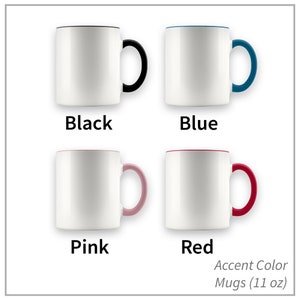 May include: Four 11-ounce white ceramic mugs with colored accents around the rim and handle. The mugs are arranged in two rows of two. The top row shows a black accent mug and a blue accent mug. The bottom row shows a pink accent mug and a red accent mug. Accent Color Mugs (11 oz)