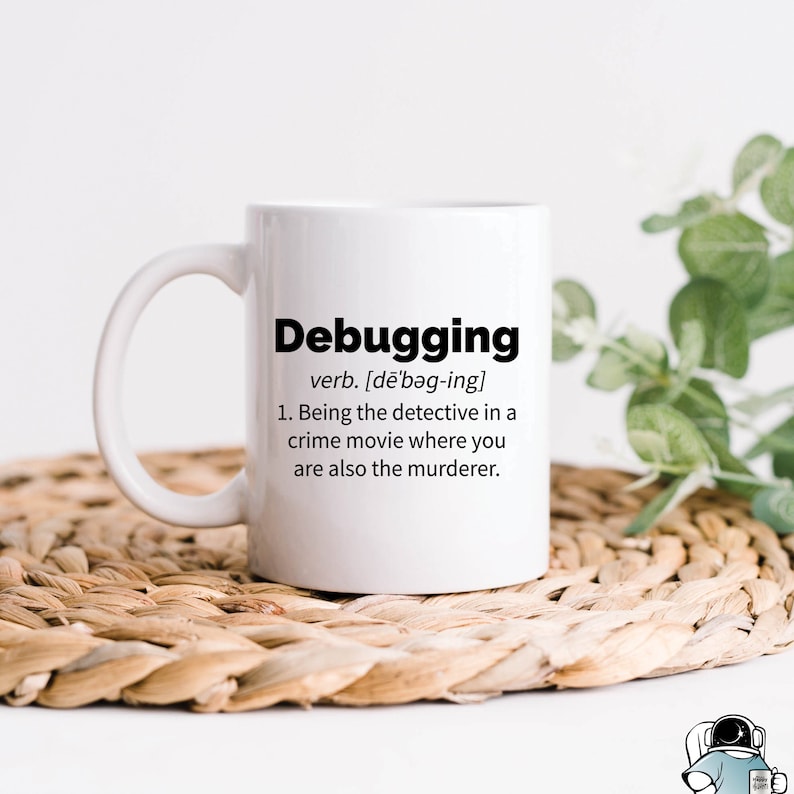 May include: White coffee mug with a black graphic that says "Debugging" and defines the word as "Being the detective in a crime movie where you are also the murderer."