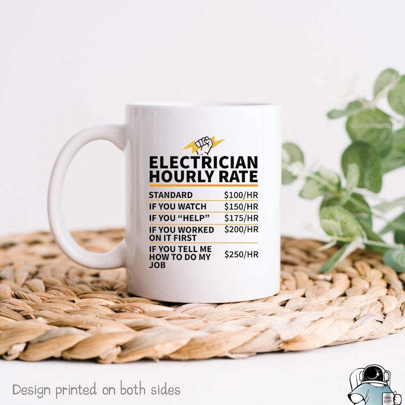 May include: White ceramic coffee mug with a black and yellow graphic that reads "Electrician Hourly Rate" with a list of rates for different levels of assistance. The text "Design printed on both sides" is at the bottom of the image.
