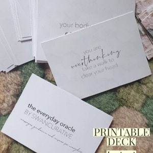 May include: A printable oracle deck with the text "the everyday oracle by SWANCURATIVE messages guidance and answers for everyday" and the text "PRINTABLE DECK Instant Download".
